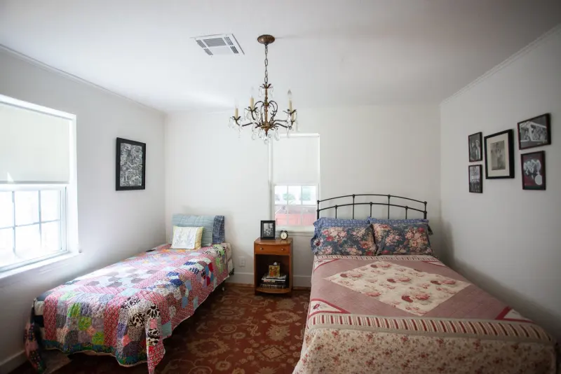 Bedroom with a full bed and a twin bed, both with quilts