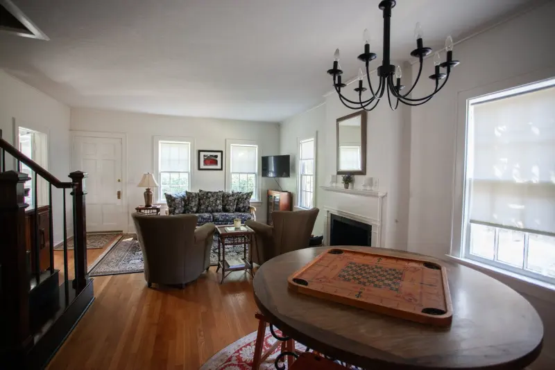 Living room with a fireplace, sofa and a round game table