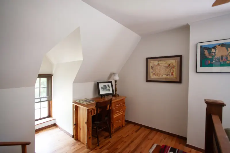 Upstairs landing with a writing desk under a dormer window